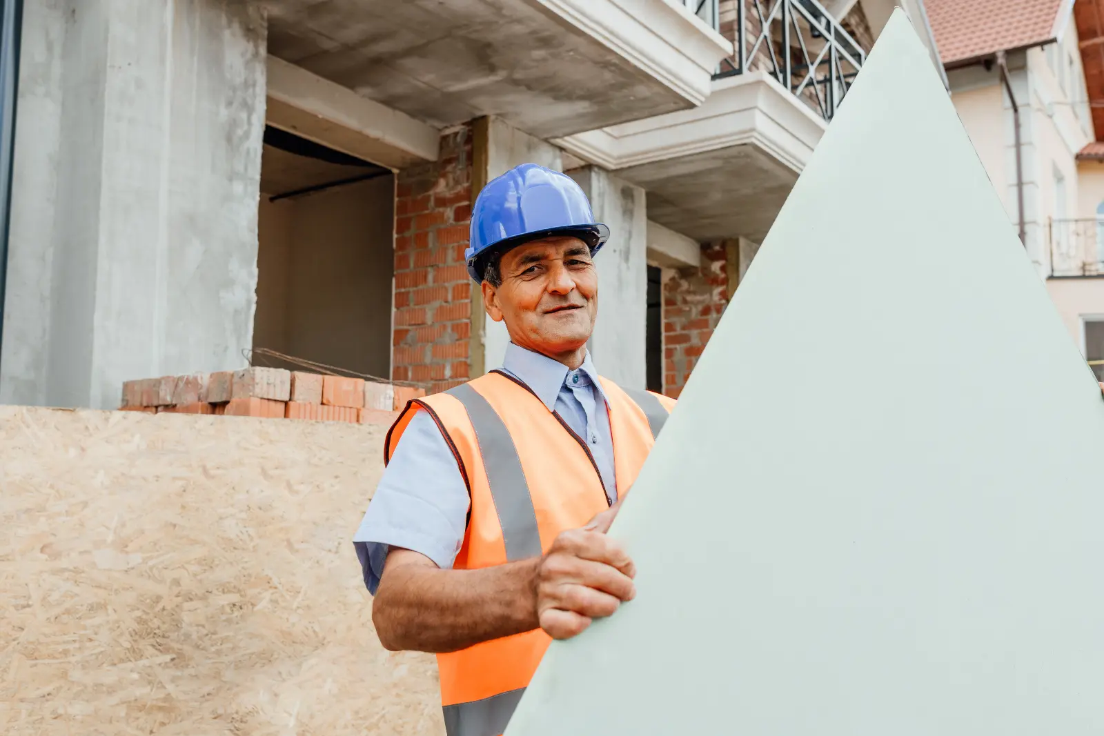 Ceiling Finishing Techniques. Happy constructor standing outside behind empty cardboard