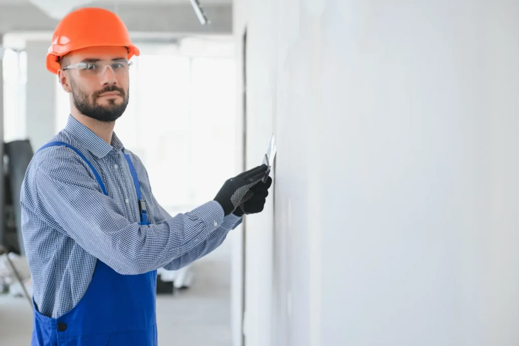 Plasterboard Repair. man drywall worker