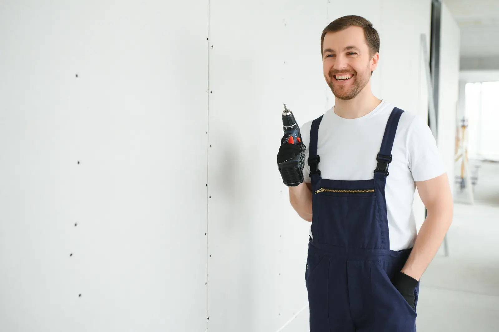 Drywall Ceiling Installation man drywall worker installing plasterboard sheet to wall